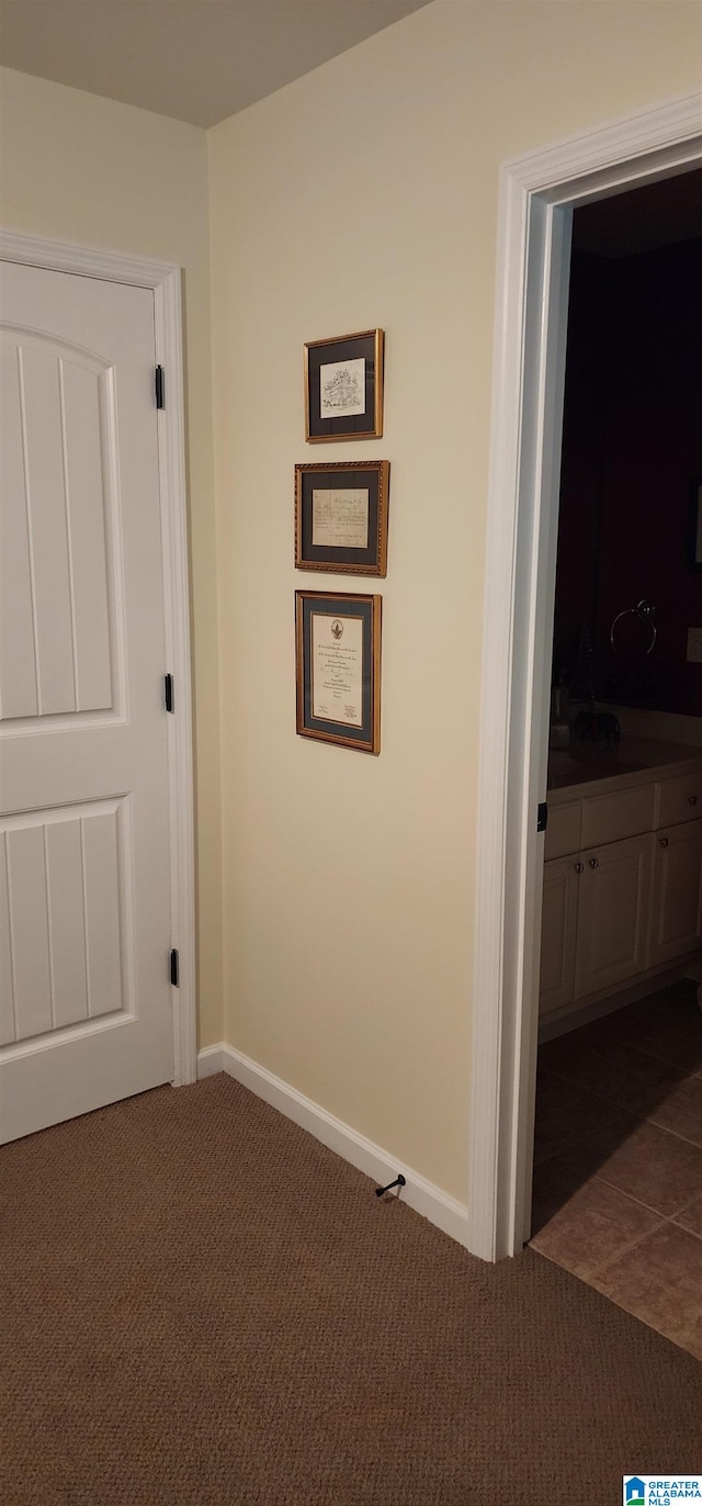 hall with dark tile floors