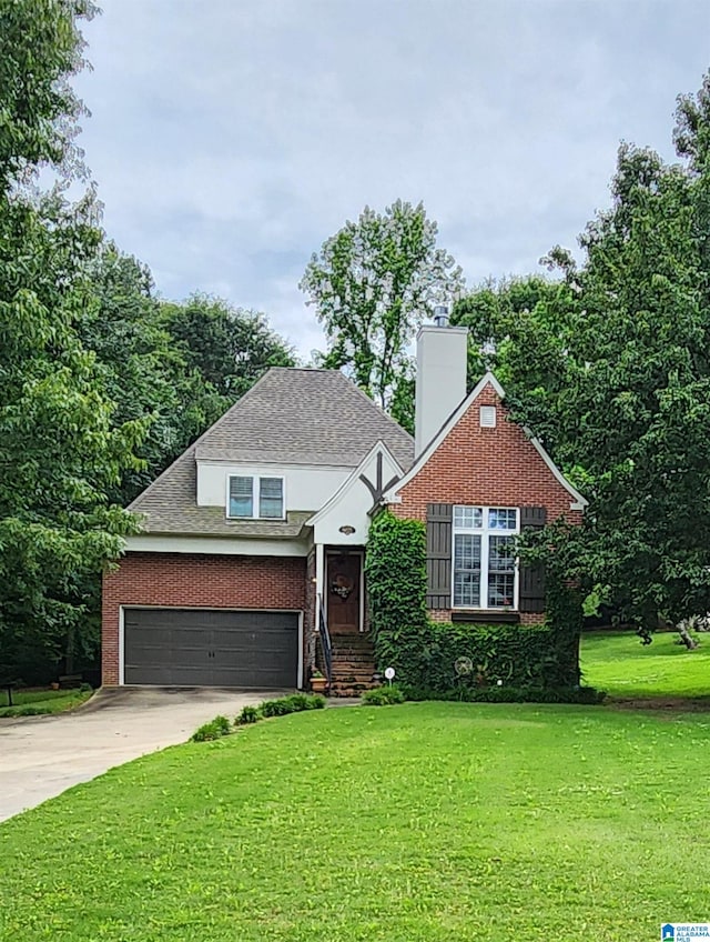 view of front of house featuring a garage and a front lawn