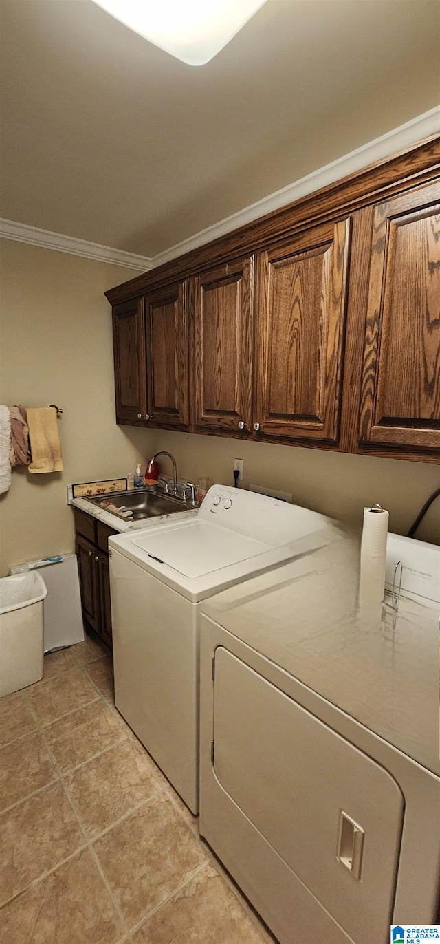 washroom with cabinets, separate washer and dryer, ornamental molding, sink, and light tile flooring