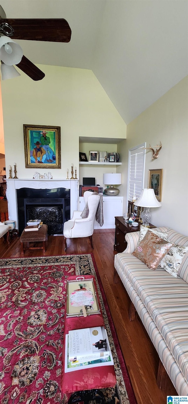 living room featuring hardwood / wood-style floors, ceiling fan, and lofted ceiling