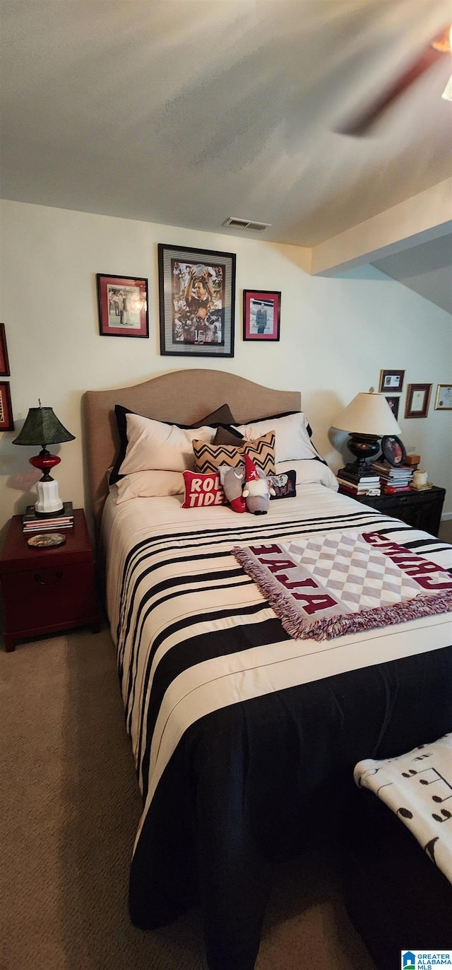 carpeted bedroom with beam ceiling and ceiling fan