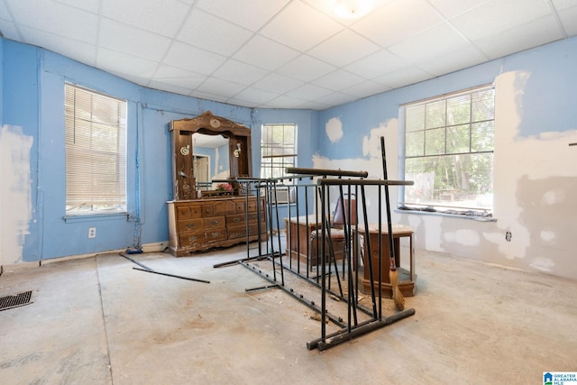 interior space with concrete flooring and a drop ceiling