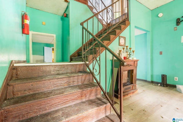 stairway featuring wood-type flooring