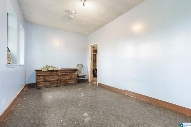 spare room with a textured ceiling