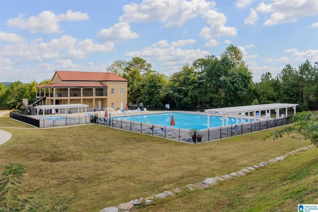 view of pool with a yard