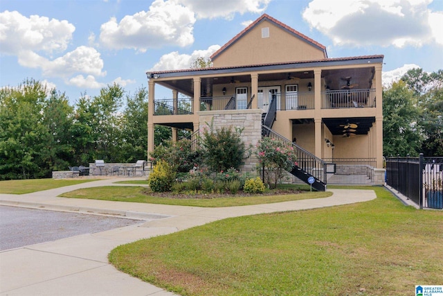 view of front of house featuring a front yard and a balcony