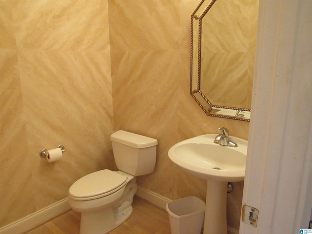 bathroom with toilet and hardwood / wood-style flooring