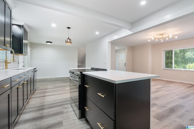 kitchen with hanging light fixtures, light hardwood / wood-style floors, a kitchen island, and stainless steel range with electric stovetop