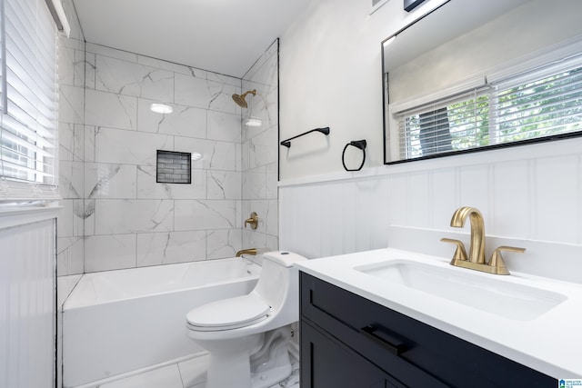 full bathroom with vanity, a healthy amount of sunlight, toilet, and tiled shower / bath