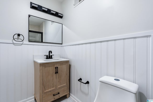 bathroom with vanity and toilet