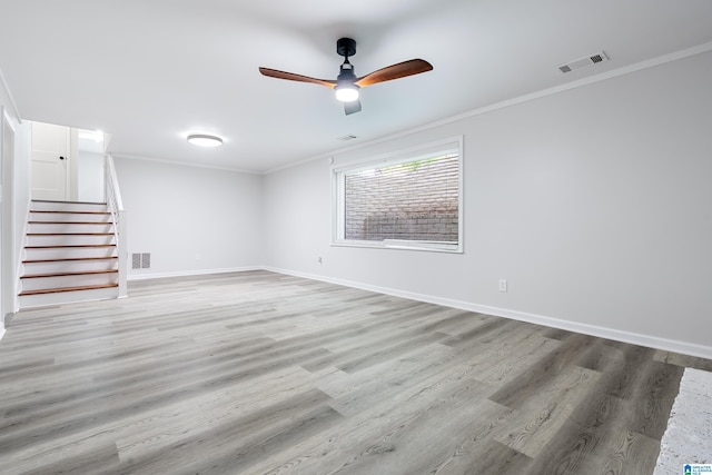 empty room featuring ceiling fan, light hardwood / wood-style floors, and ornamental molding