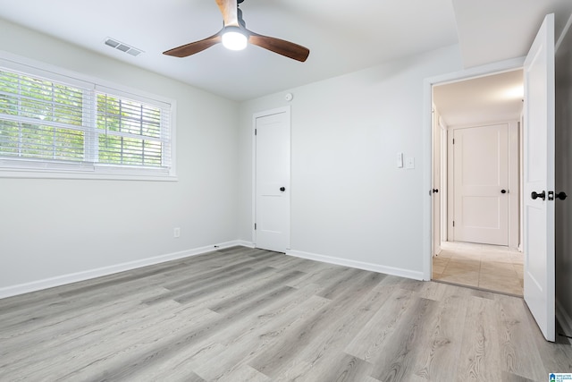 unfurnished bedroom with light hardwood / wood-style flooring and ceiling fan