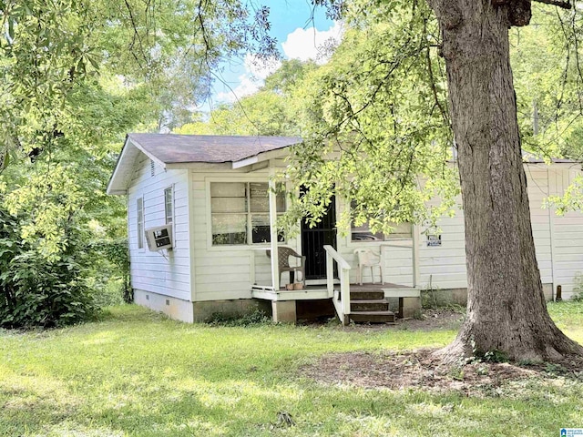 view of front of property featuring cooling unit and a front yard