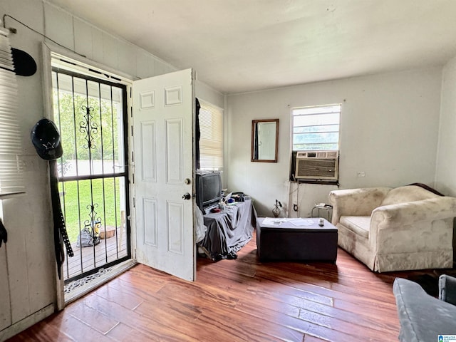 foyer featuring wood-type flooring, a wealth of natural light, and cooling unit