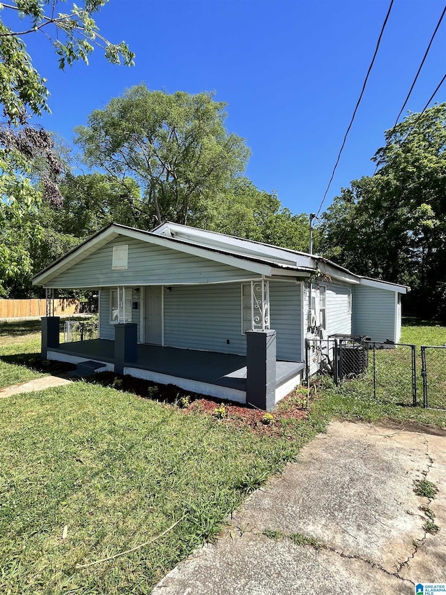 view of front facade with covered porch, central air condition unit, and a front yard