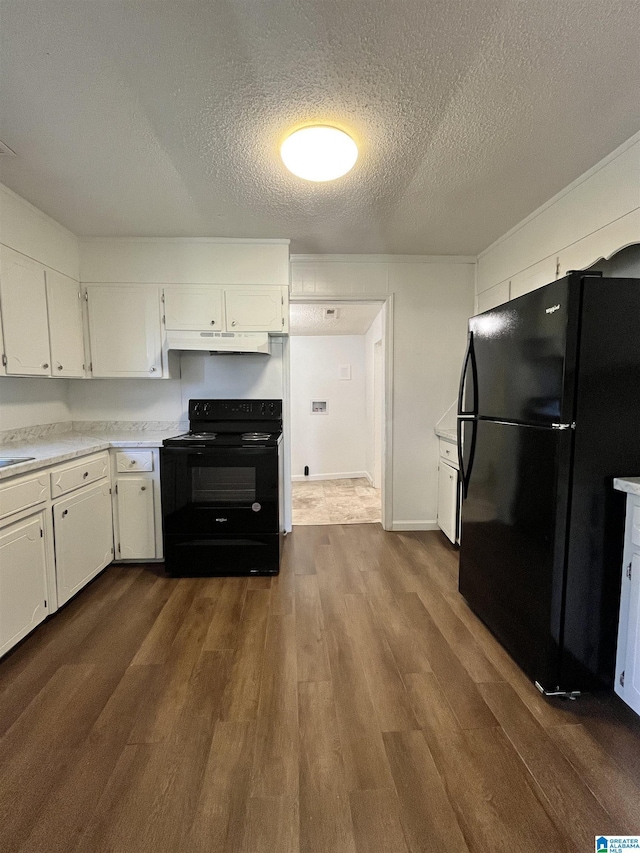 kitchen featuring black appliances, dark hardwood / wood-style flooring, white cabinets, and a textured ceiling