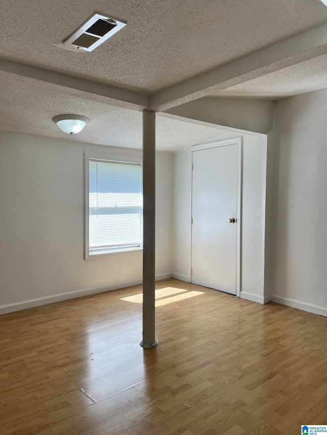 interior space with hardwood / wood-style floors and a textured ceiling