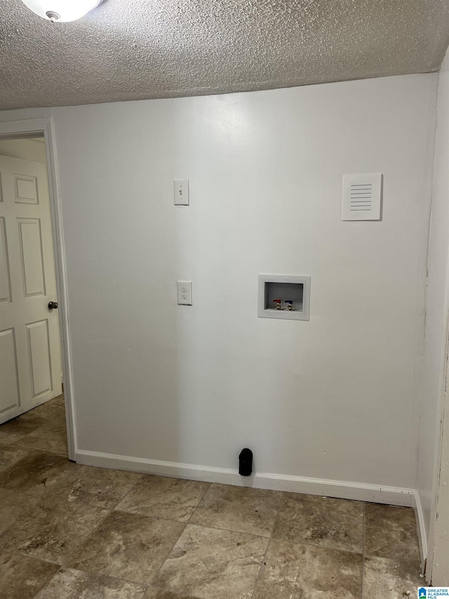 laundry room with a textured ceiling and hookup for a washing machine