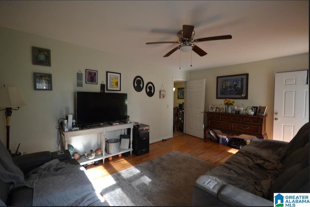 living room featuring ceiling fan and wood-type flooring