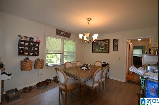 dining space featuring a notable chandelier and hardwood / wood-style floors