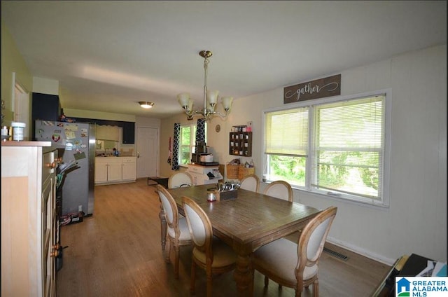 dining room featuring a notable chandelier and hardwood / wood-style floors