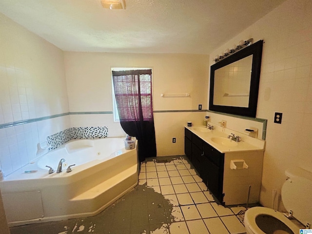 bathroom with vanity, tile patterned floors, a bathtub, and toilet