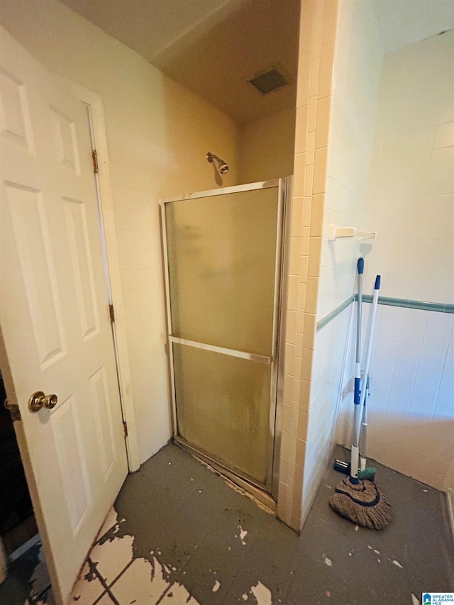 bathroom featuring a shower with shower door