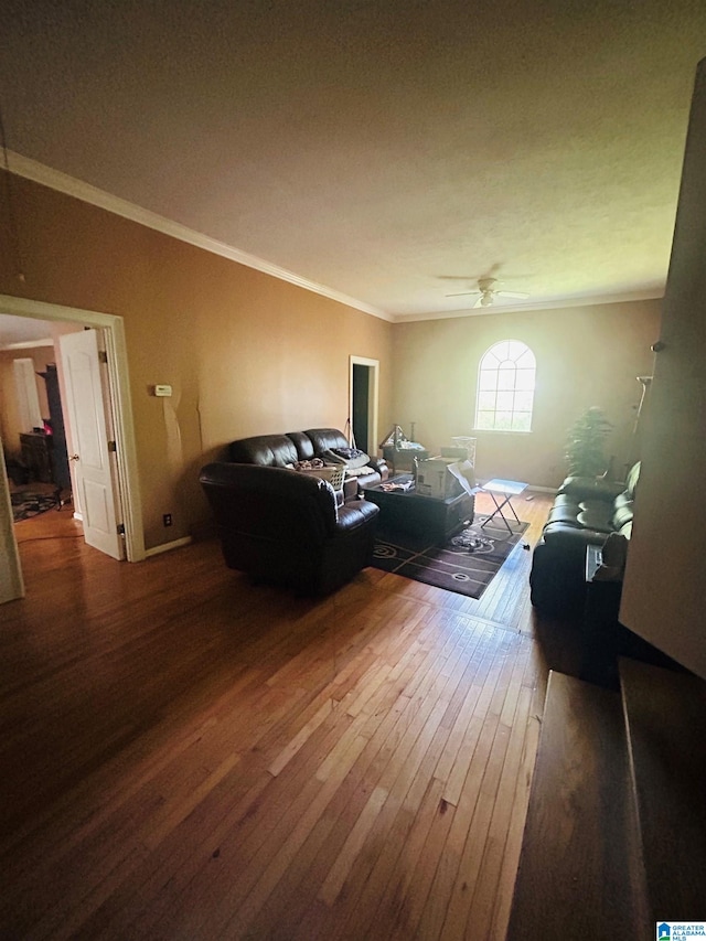 living room featuring hardwood / wood-style flooring, ceiling fan, lofted ceiling, and crown molding