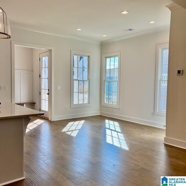 interior space featuring ornamental molding and dark hardwood / wood-style floors