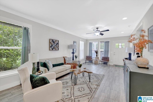 living room with ceiling fan, light hardwood / wood-style flooring, and ornamental molding