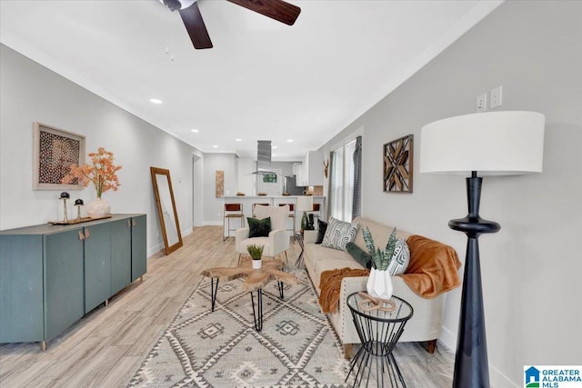 living room featuring ceiling fan and light wood-type flooring