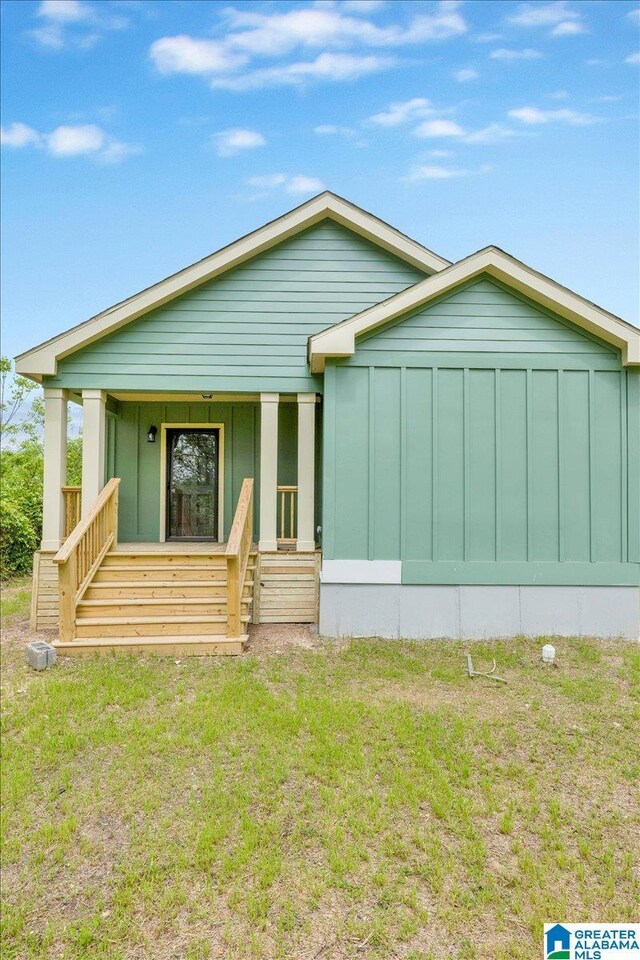 view of front of home featuring covered porch and a front yard