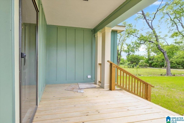 wooden deck featuring a yard