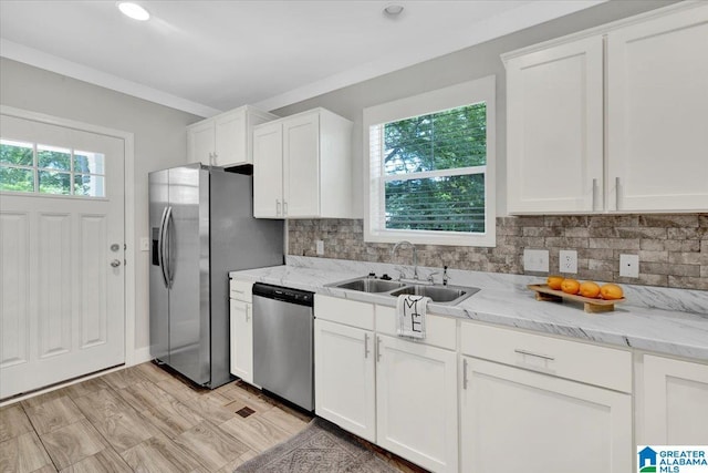 kitchen with white cabinets, appliances with stainless steel finishes, and sink