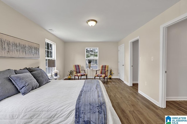 bedroom with dark hardwood / wood-style floors