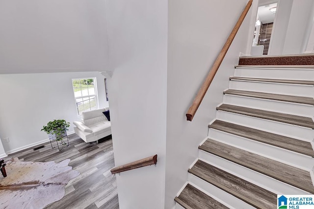 stairs featuring wood-type flooring