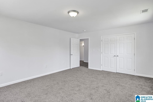 unfurnished bedroom featuring carpet flooring and a closet