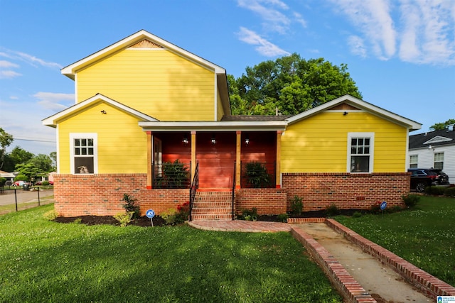 view of front of house with covered porch and a front lawn