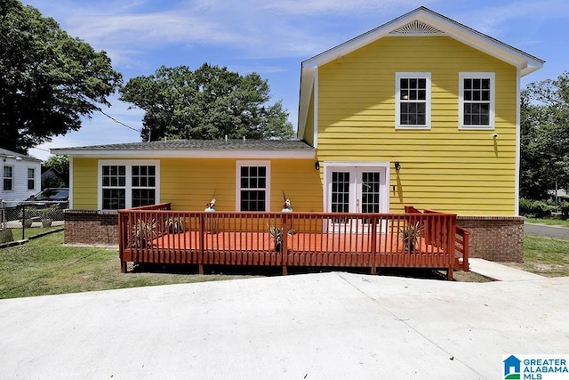 back of house with a deck