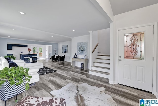 entrance foyer featuring hardwood / wood-style floors, french doors, and ornamental molding