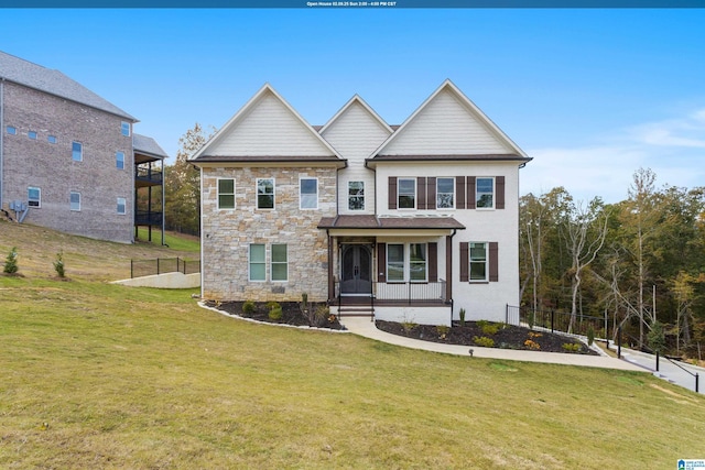 view of front of home with covered porch and a front lawn