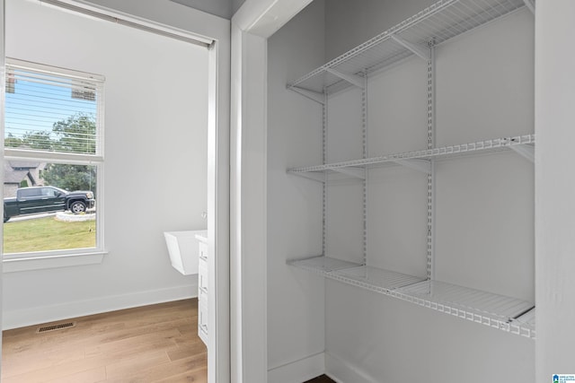 walk in closet featuring hardwood / wood-style flooring