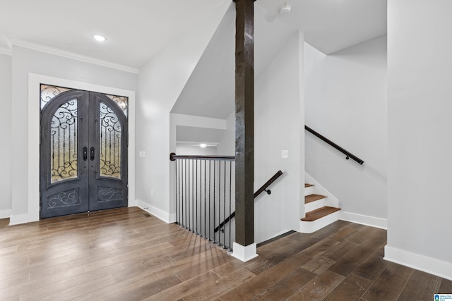 foyer entrance featuring dark hardwood / wood-style flooring and french doors