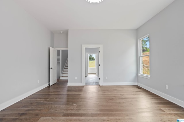 empty room featuring dark wood-type flooring