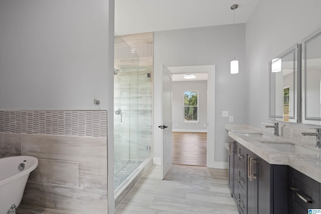 bathroom with vanity, plus walk in shower, and tile walls