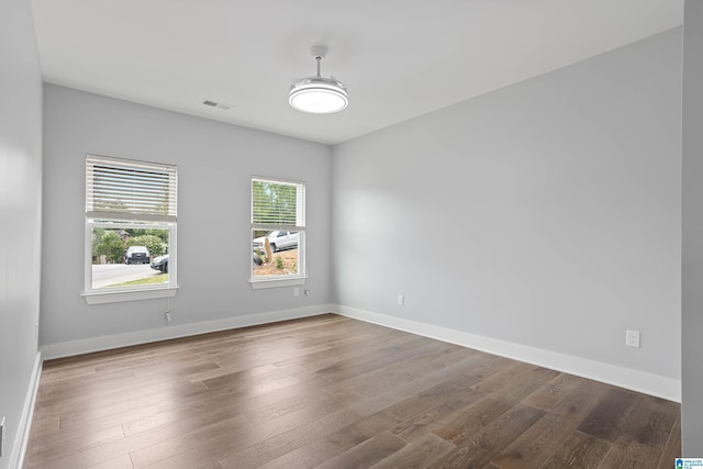 unfurnished room with hardwood / wood-style floors