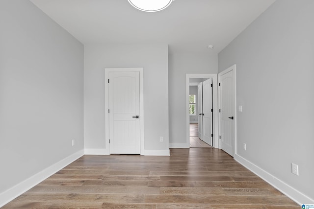 unfurnished bedroom with wood-type flooring