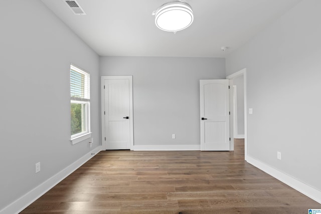 empty room featuring hardwood / wood-style flooring