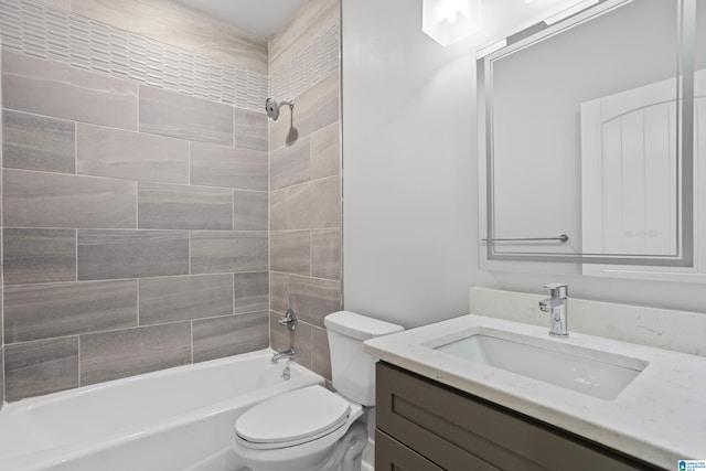 full bathroom featuring vanity, tiled shower / bath combo, and toilet