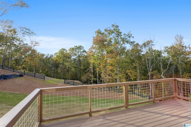 wooden terrace featuring a yard